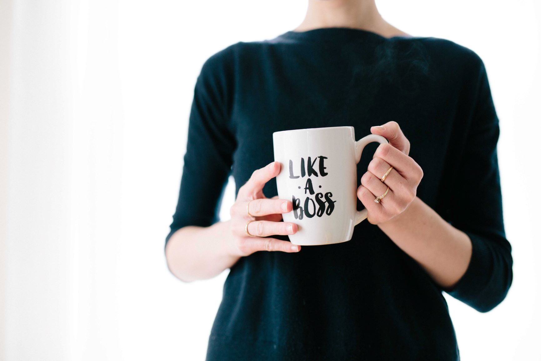 Woman holding mug with the words on it: "like a boss" 