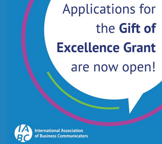 Blue background with pink and green circular lines and a white speech balloon that says, "Applications for the Gift of Excellence Grant are now open!"