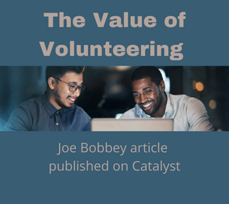 The Value of Volunteering - Joe Bobbey article published on Catalyst - image of two men in front of a laptop, smiling