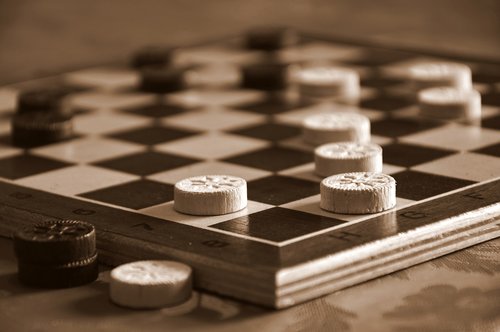 Brown & cream checkers set, with the copy: "Game Changing Resources & Tips"